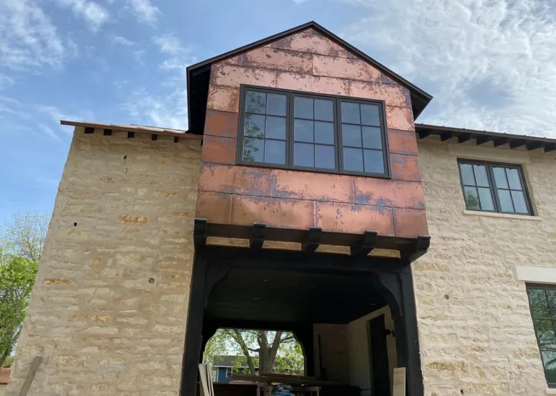 Copper metal panel facade on a stone building for Roof Repair in Shawnee